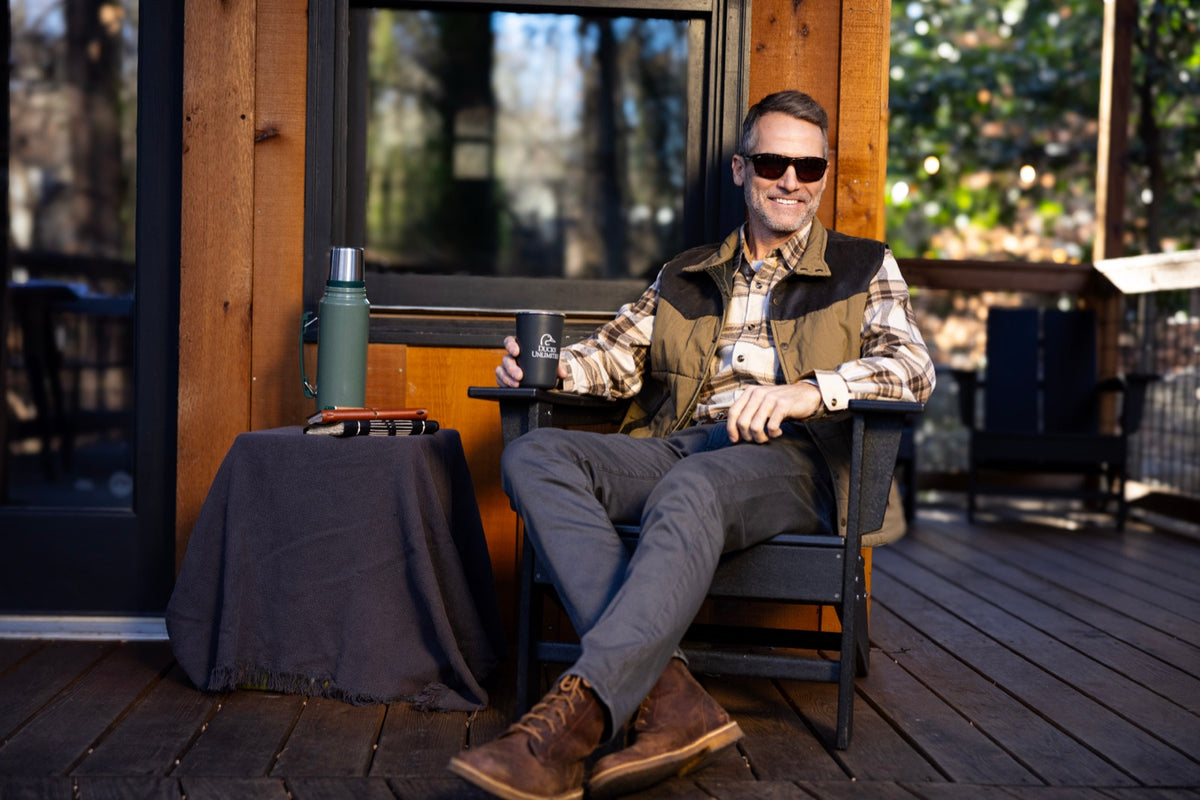 Man on a porch at the end of the day wearing Honey Hole sunglasses